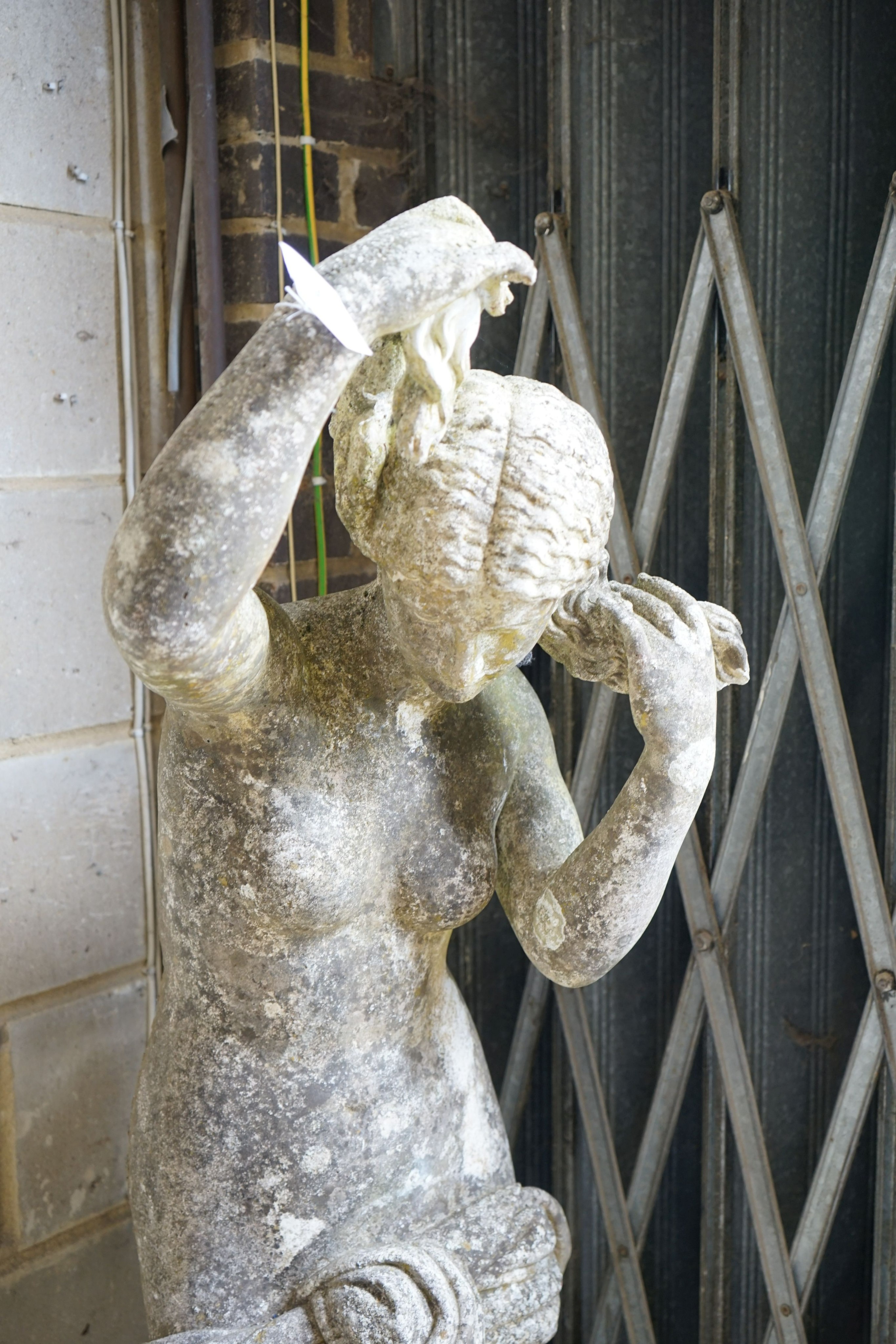 A weathered reconstituted stone garden statue of a robed female figure, height 155cm